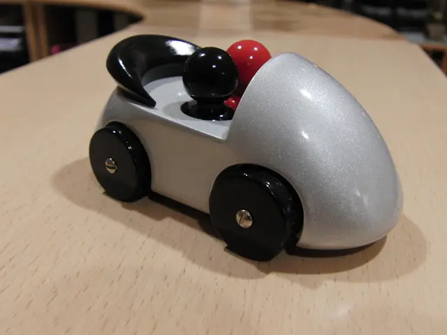 In this image on a table there is a toy car.