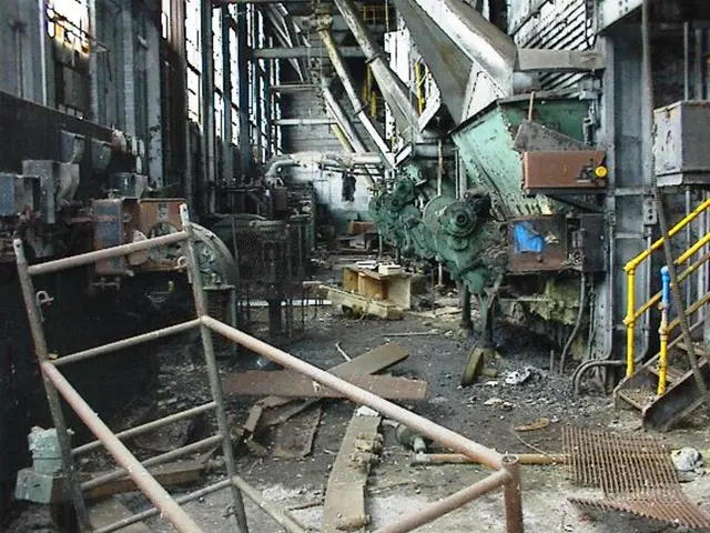 There is a old factory with a machinery located inside it. There are some windows in this room....