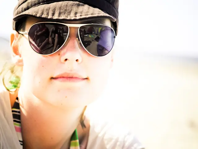 A woman is there, she wore goggles, cap and a white color t-shirt.