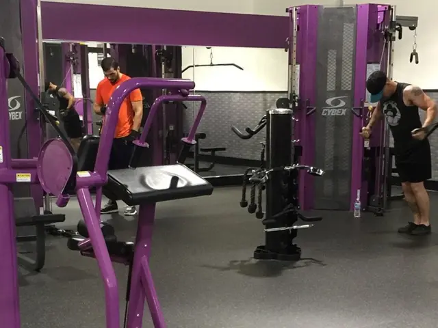 This is the inner view of a gym where we can see few equipment and we can see this person wearing a...