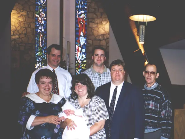 Here we can see people. This woman is holding a baby. This is light.