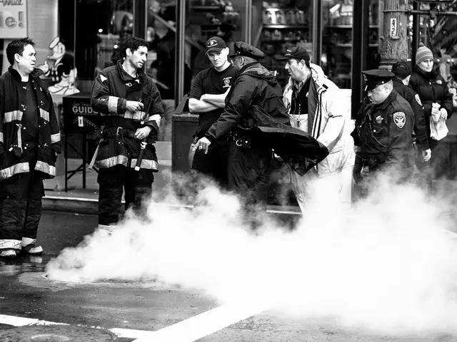 This is a black and white image where we can see these persons are standing on the road. Here we...